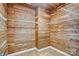Walk-in closet with custom wood paneling and shelving units at 305 Chancelot Ln, Fort Mill, SC 29708