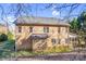 Back exterior of brick house with lawn, fence, screened in porch, and mature trees at 305 Chancelot Ln, Fort Mill, SC 29708