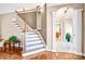 Welcoming foyer with staircase, hardwood flooring, and traditional trim at 305 Chancelot Ln, Fort Mill, SC 29708