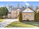 Inviting brick home boasts a well-maintained lawn and attached two-car garage at 305 Chancelot Ln, Fort Mill, SC 29708