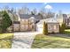 Charming brick home with manicured lawn, long driveway, and attached two-car garage at 305 Chancelot Ln, Fort Mill, SC 29708