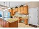 Bright kitchen featuring granite countertops, wood cabinets, and stainless steel appliances at 305 Chancelot Ln, Fort Mill, SC 29708