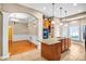 Open kitchen featuring a large island, granite counters, and view to the formal dining room at 305 Chancelot Ln, Fort Mill, SC 29708