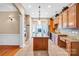 Spacious kitchen boasts granite countertops, wood cabinets, and a central island at 305 Chancelot Ln, Fort Mill, SC 29708