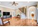 Spacious living room featuring hardwood floors, staircase and neutral paint at 305 Chancelot Ln, Fort Mill, SC 29708