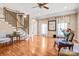 Bright and airy living room with hardwood floors, staircase, and large windows at 305 Chancelot Ln, Fort Mill, SC 29708