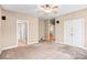 Spacious main bedroom with plush carpet, ceiling fan and a glimpse of the en-suite bathroom at 305 Chancelot Ln, Fort Mill, SC 29708