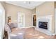 Bright sitting room with fireplace, tile floors, and french door to patio at 305 Chancelot Ln, Fort Mill, SC 29708