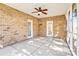 Enclosed sunroom with brick walls, ceiling fan, and concrete flooring offers a relaxing indoor-outdoor space at 305 Chancelot Ln, Fort Mill, SC 29708