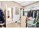 Spacious walk-in closet featuring custom shelving, natural light, and access to the bathroom at 305 Chancelot Ln, Fort Mill, SC 29708