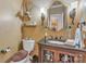 Charming powder room with decorative mirror, sconces, and vanity with granite countertop at 3759 Sand Wedge Dr, Gastonia, NC 28056