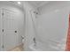 Bathroom with a white door and shower/tub combination at 3759 Sand Wedge Dr, Gastonia, NC 28056