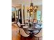Elegant dining room with hardwood floors, chandelier, and ample natural light from surrounding windows at 3759 Sand Wedge Dr, Gastonia, NC 28056