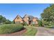 Charming brick home features manicured landscaping, a circular driveway, and a welcoming front entrance at 3759 Sand Wedge Dr, Gastonia, NC 28056