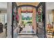 Grand front entrance with detailed iron doors and brick exterior, framed by manicured landscaping at 3759 Sand Wedge Dr, Gastonia, NC 28056