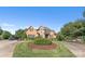 Beautiful brick home featuring a circular driveway, lush landscaping, and a well-manicured front lawn at 3759 Sand Wedge Dr, Gastonia, NC 28056