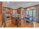 Spacious kitchen features wood cabinetry, granite countertops, stainless steel appliances, and an eat-in area at 3759 Sand Wedge Dr, Gastonia, NC 28056