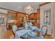 Kitchen and dining area with wood cabinets, granite counters, and decorative chandelier at 3759 Sand Wedge Dr, Gastonia, NC 28056