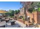 Charming outdoor area with stone fireplace, brick accents, and comfortable seating at 3759 Sand Wedge Dr, Gastonia, NC 28056