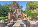 Cozy outdoor fireplace with stone accents and ample seating area at 3759 Sand Wedge Dr, Gastonia, NC 28056