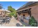 Outdoor kitchen featuring a grill, brick surround, and patio seating at 3759 Sand Wedge Dr, Gastonia, NC 28056