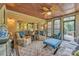 Inviting sunroom with wood ceiling, brick accent, comfortable seating, and lots of natural light at 3759 Sand Wedge Dr, Gastonia, NC 28056