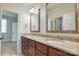 Bathroom with double sink vanity and granite counters, wood cabinets and neutral color scheme at 4124 Sherbrooke Dr, Charlotte, NC 28210
