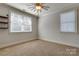 Comfortable carpeted bedroom with ceiling fan, windows for natural light, and neutral colors at 4124 Sherbrooke Dr, Charlotte, NC 28210