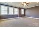 Spacious bedroom with triple windows providing natural light and a ceiling fan at 4124 Sherbrooke Dr, Charlotte, NC 28210