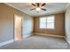 Cozy bedroom featuring neutral paint, a ceiling fan, and a window providing lots of natural light at 4124 Sherbrooke Dr, Charlotte, NC 28210