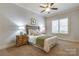 Inviting bedroom with a decorative headboard, ceiling fan and plantation shutters at 4124 Sherbrooke Dr, Charlotte, NC 28210