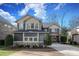 Beautiful two-story home with stone accents, a well-manicured lawn, and neutral-colored siding at 4124 Sherbrooke Dr, Charlotte, NC 28210