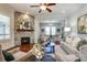 Elegant living room featuring a stone fireplace, ceiling fan and warm hardwood floors at 4124 Sherbrooke Dr, Charlotte, NC 28210