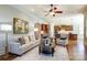 Bright living room showcasing hardwood floors, neutral furnishings, and an open layout to the kitchen at 4124 Sherbrooke Dr, Charlotte, NC 28210
