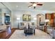 Inviting living room with hardwood floors, a ceiling fan, and open access to the kitchen at 4124 Sherbrooke Dr, Charlotte, NC 28210
