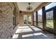 Outdoor patio features a stone fireplace, tile flooring, and comfortable seating area at 4124 Sherbrooke Dr, Charlotte, NC 28210