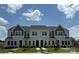 Charming two-story townhomes featuring classic architecture and a well-manicured lawn at 4714 Lakeview Rd # 11, Charlotte, NC 28216