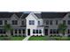 Modern townhome featuring a clean white facade, dark roof, and well-manicured front lawn at 4714 Lakeview Rd # 11, Charlotte, NC 28216