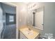 Bathroom featuring an oval sink, a large mirror and a door to another room at 6126 Eagle Peak Dr, Charlotte, NC 28214