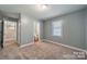 Carpeted bedroom features natural light, access to stairs and leads into the bathroom at 6126 Eagle Peak Dr, Charlotte, NC 28214