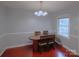 Well-lit dining room with an oval wood table, traditional chandelier, and window view at 6126 Eagle Peak Dr, Charlotte, NC 28214