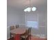 Dining area featuring a modern lamp above a wood dining table with chairs at 6126 Eagle Peak Dr, Charlotte, NC 28214