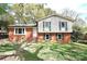 Two story home featuring brick facade and upper level vinyl siding and a front yard at 6126 Eagle Peak Dr, Charlotte, NC 28214