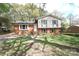 View of the home showing the lawn and a two-story home with brick and vinyl siding at 6126 Eagle Peak Dr, Charlotte, NC 28214