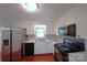 Bright kitchen features white cabinets, stainless steel refrigerator and black appliances at 6126 Eagle Peak Dr, Charlotte, NC 28214