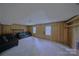 Large carpeted living room features wood paneled walls, and two large sofas at 6126 Eagle Peak Dr, Charlotte, NC 28214