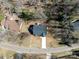 Aerial view of house with a deck and large backyard surrounded by trees at 619 Berkshire Dr, Statesville, NC 28677