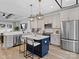 Charming kitchen features a blue island, modern appliances, and pendant lighting at 619 Berkshire Dr, Statesville, NC 28677