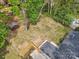 Aerial view of backyard with mature trees and shed, fenced for privacy, and lush lawn at 6813 Elm Forest Dr, Charlotte, NC 28212