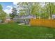 View of spacious backyard featuring a well-maintained lawn and a wood fence for privacy and space at 6813 Elm Forest Dr, Charlotte, NC 28212